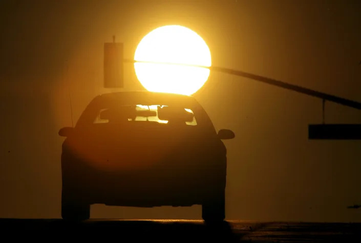 Motorists drive west toward the setting sun.