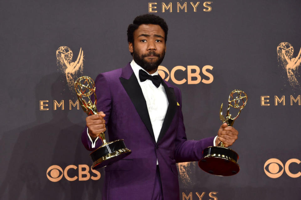 Donald Glover holding two Emmys