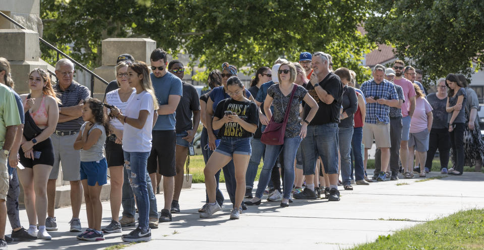 A long line of voters wraps around the Sedgwick County Historic Courthouse in Wichita, Kan., on the last day of early voting on Aug. 1.