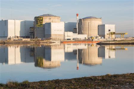 Greenpeace activists display an anti-nuclear banner after entering a nuclear power plant operated by EDF in Fessenheim, eastern France, March 18, 2014. REUTERS/Bente Stachowske/Greenpeace/Handout via Reuters