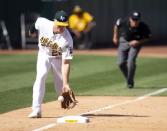 Mar 31, 2019; Oakland, CA, USA; Oakland Athletics third baseman Matt Chapman (26) fields a ground ball off the bat of Los Angeles Angels designated hitter Mike Trout, as third base umpire Chris Guccione looks down the foul line during the ninth inning of a Major League Baseball game at Oakland Coliseum. Umpires ultimately ruled it a foul ball. Mandatory Credit: D. Ross Cameron-USA TODAY Sports