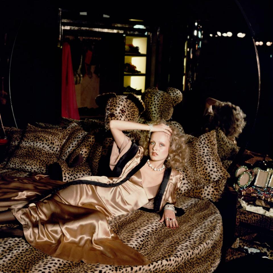 Twiggy stretches out on a leopardskin bed at Biba's Kensington store, 1971