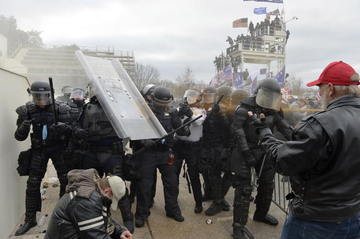 Trump supporters clash with police and security forces as they try to storm the US Capitol in Washington, DC on January 6, 2021.