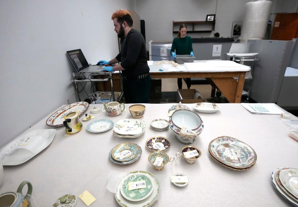 A portion of the barcoded Milwaukee Public Museum’s British ceramics collection are organized on a table before being logged in and packed by Milwaukee Public Museum collections move technicians Quinn Tahon (left), and Corinne Roth as they work on packing up the collection at the Milwaukee Public Museum in Milwaukee in preparation for move to the new museum, on Tuesday, Feb. 27, 2024. Once the packing of priceless artifacts takes place, they are loaded onto trucks and moved either to a secure, off-site storage facility or to the future museum, set to open in 2027.