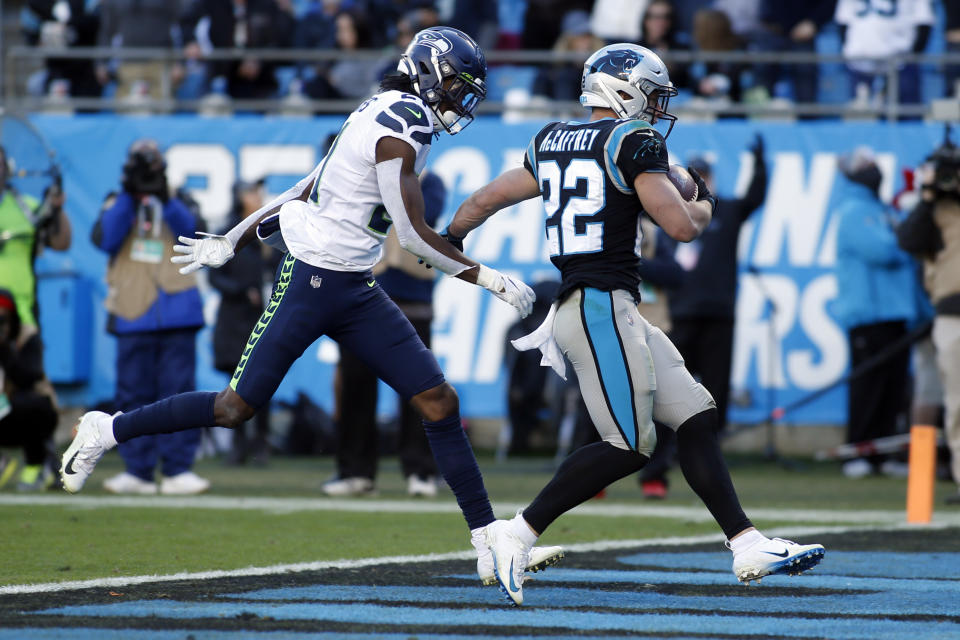 Carolina Panthers running back Christian McCaffrey (22) runs into the end zone for a touchdown as Seattle Seahawks cornerback Tre Flowers (21) chases during the second half of an NFL football game in Charlotte, N.C., Sunday, Dec. 15, 2019. (AP Photo/Brian Blanco)