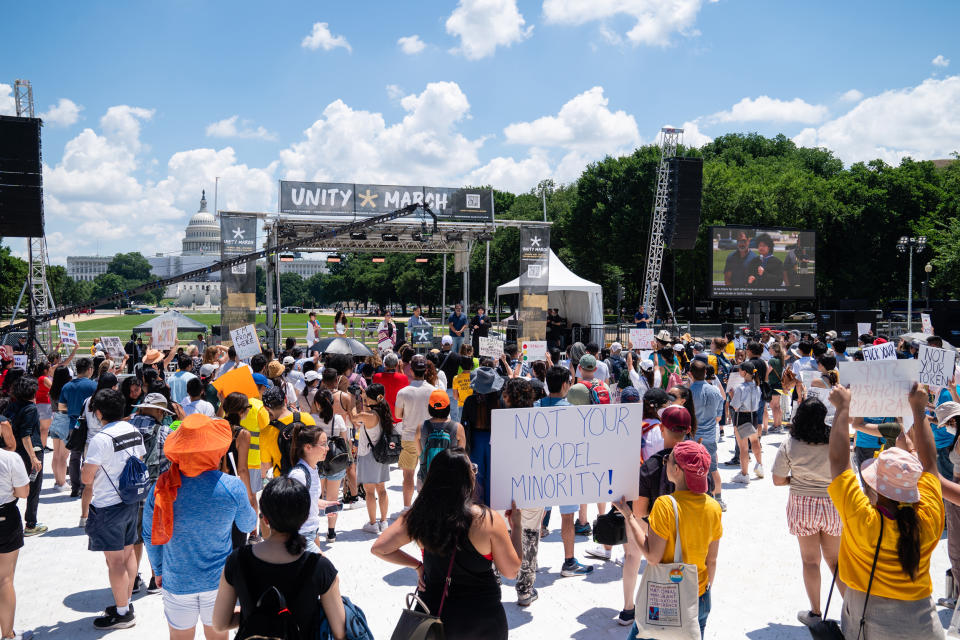 Demonstrators listen to speakers during the Unity March rally (Eric Lee / Bloomberg via Getty Images)