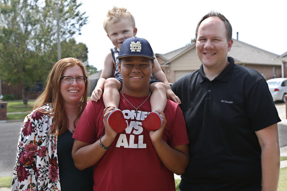 The Dunn family is pictured outside their home Friday, June 12, 2020, in Oklahoma City. From left Sarah Dunn, Cooper Dunn, Izzy Simons and Josh Dunn. Sarah Dunn, who grew up in rural Kansas, has learned much about race since she and her husband, Josh, took custody of Izzy six years ago. (AP Photo/Sue Ogrocki)
