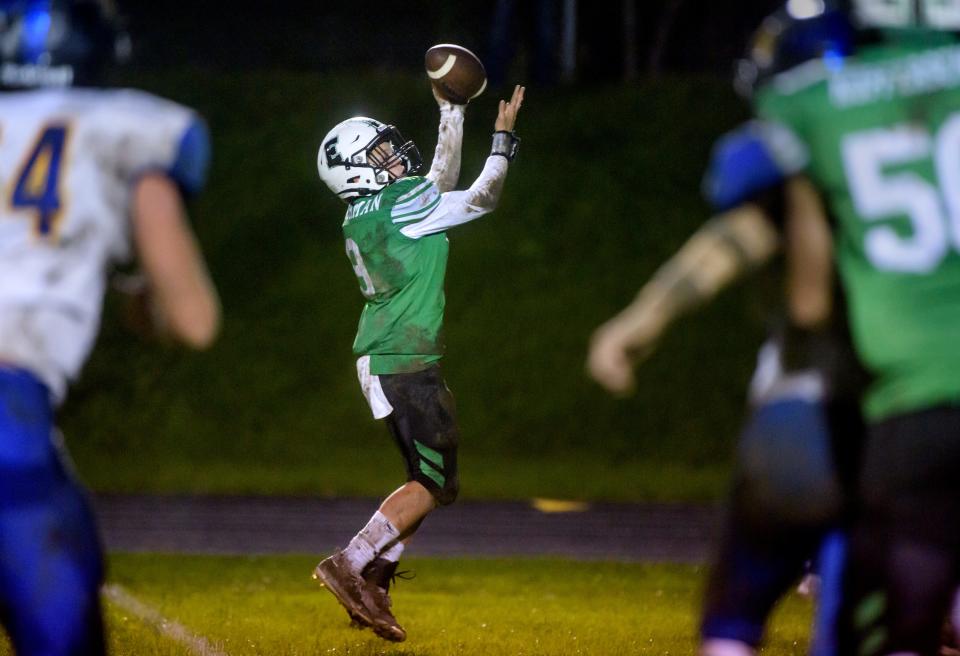 Eureka's Justis Bachman snags a pass over the Downs Tri-Valley defense in the first half Friday, Oct. 15, 2021 in Eureka. The Hornets fell to the Vikings 29-7.