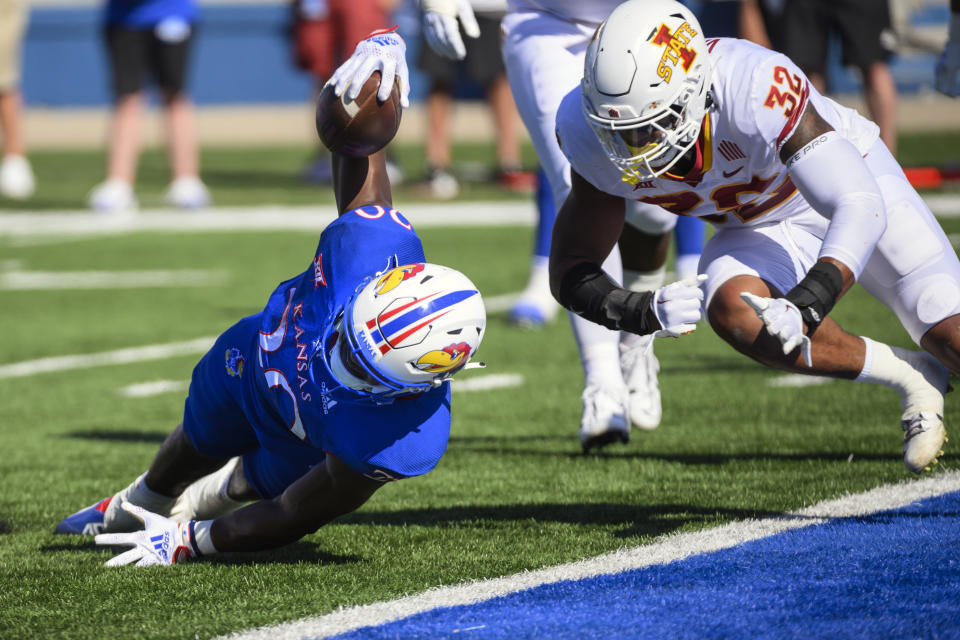 Kansas running back Daniel Hishaw Jr. (30) dives into the end zone ahead of Iowa State linebacker Gerry Vaughn (32) for a touchdown during the first half of an NCAA college football game, Saturday, Oct. 1, 2022, in Lawrence, Kan. (AP Photo/Reed Hoffmann)