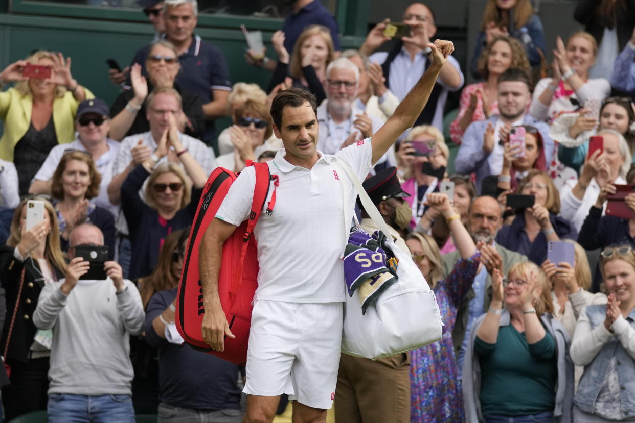 Switzerland's Roger Federer leaves the court after being defeated by Poland's Hubert Hurkacz during the men's singles quarterfinals match on day nine of the Wimbledon Tennis Championships in London, Wednesday, July 7, 2021. (AP Photo/Kirsty Wigglesworth)