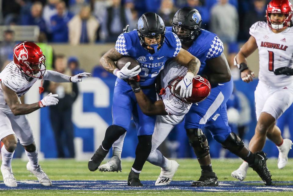 Kentucky running back Chris Rodriguez gains yardage against Louisville in the second half as the Wildcats beat the No. 25 Cards 26-13 in Saturday's Battle of the Bluegrass college football game. Nov. 26, 2022.  