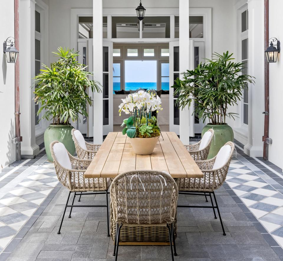 An two-story, open-to-the-sky dining atrium is a central feature of a house just listed for $78.5 million at 2315 S. Ocean Blvd. in Palm Beach. The ocean can be seen through the living room at the rear.