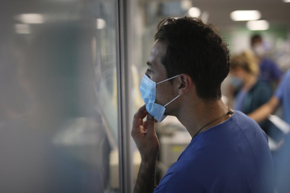 A medical worker watches COVID-19 patients in a Marseille hospital, southern France, Thursday, Sept.10, 2020. As the Marseille region has become France's latest virus hotspot, hospitals are re-activating emergency measures in place when the pandemic first hit to ensure they're able to handle growing new cases. (AP Photo/Daniel Cole)