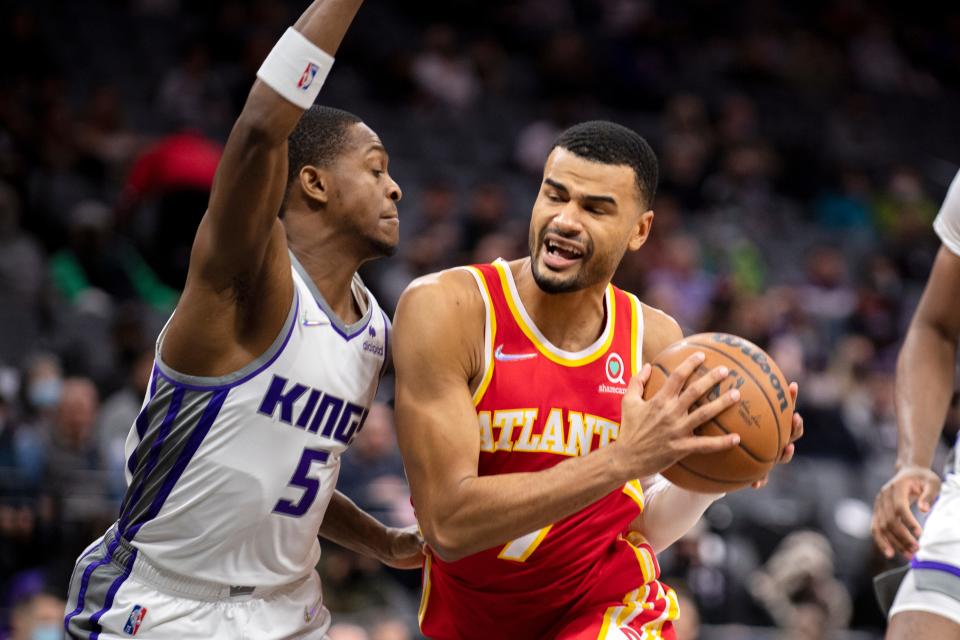 Sacramento Kings guard De'Aaron Fox (5) defends Atlanta Hawks guard Timothe Luwawu-Cabarrot (7) during the first quarter of an NBA basketball game in Sacramento, Calif., Wednesday, Jan. 5, 2022. (AP Photo/José Luis Villegas)