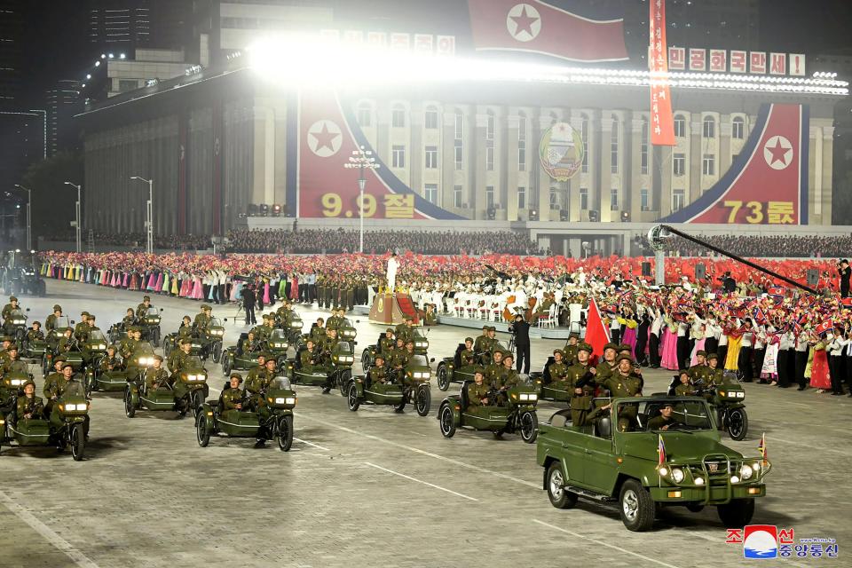 North Korean solders parading on vehicles.