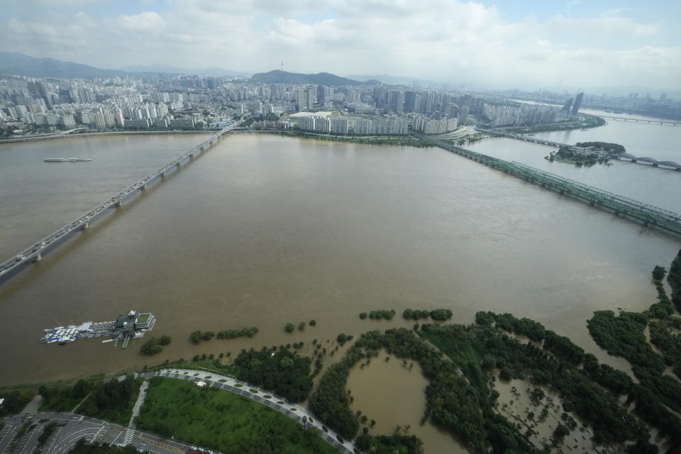 The Han River, swollen with floodwater, flows under bridges in Seoul, South Korea, Wednesday, Aug. 10, 2022. Cleanup and recovery efforts gained pace in South Korea's greater capital region Wednesday as skies cleared after two days of record-breaking rainfall that unleashed flash floods, damaged thousands of buildings and roads and killed multiple people. (AP Photo/Ahn Young-joon)
