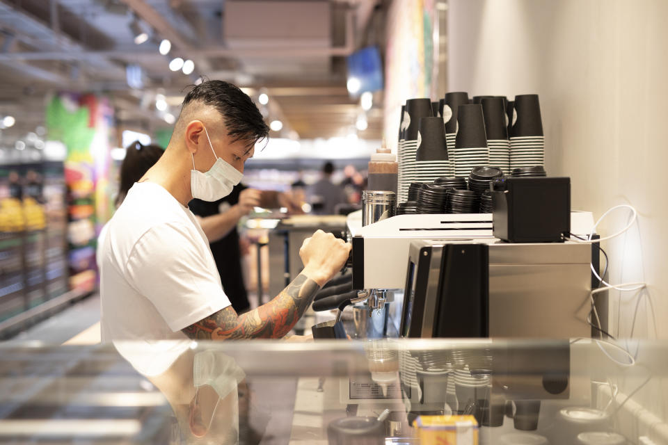 A man makes a coffee at the Aldi coffee shop North Sydney.