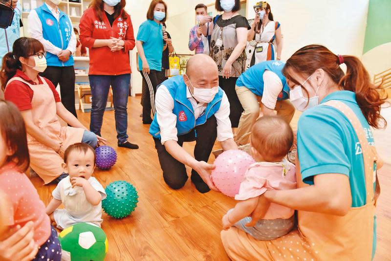 低調避戰的韓國瑜28日赴鹽埕公共托育家園揭牌、親近孩童，並開出7月提高托育人員薪資的承諾。（高雄市政府提供）