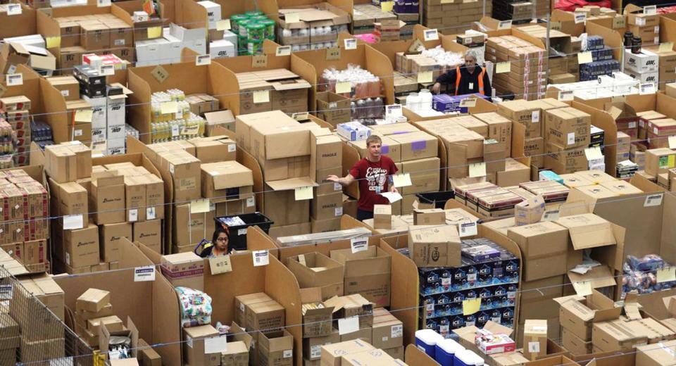 Parcels are processed and prepared for dispatch at Amazon's fulfilment centre in Peterborough