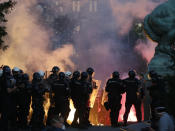 Serbian riot police clashes with protesters in Belgrade, Serbia, Wednesday, July 8, 2020. Serbia's president Aleksandar Vucic backtracked Wednesday on his plans to reinstate a coronavirus lockdown in Belgrade after thousands protested the move and violently clashed with the police in the capital. (AP Photo/Darko Vojinovic)