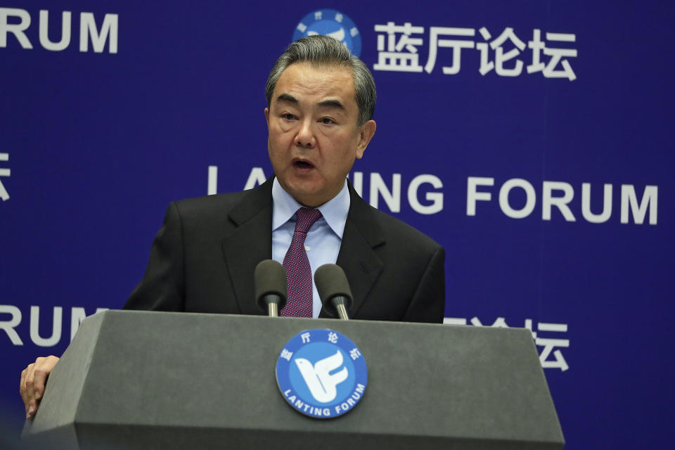 Chinese Foreign Minister Wang Yi delivers his opening remarks at the Lanting Forum on bringing China-U.S. relations back to the right track, at the Ministry of Foreign Affairs office in Beijing on Monday, Feb. 22, 2021. Wang Yi called on the U.S. Monday to lift restrictions on trade and people-to-people contacts while ceasing what Beijing considers unwarranted interference in the areas of Taiwan, Hong Kong, Xinjiang and Tibet. (AP Photo/Andy Wong)