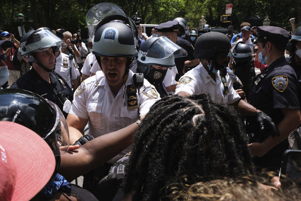 Black Lives Matter protesters and NYPD officers have a confrontation near City Hall Park, Wednesday, July 15, 2020, in New York. (AP Photo/Yuki Iwamura)