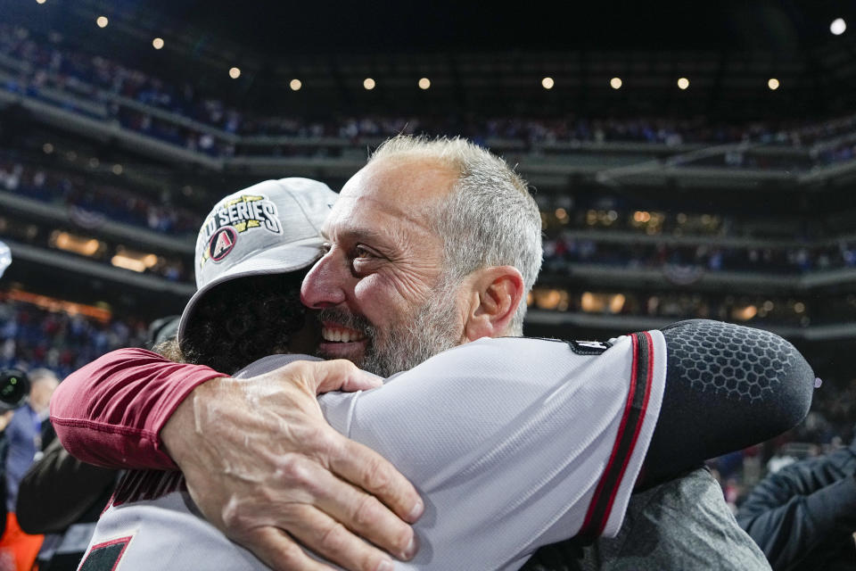 The Arizona Diamondbacks manager Torey Lovullo hugs Alek Thomas after their win against the Philadelphia Phillies in Game 7 of the baseball NL Championship Series in Philadelphia Tuesday, Oct. 24, 2023. (AP Photo/Brynn Anderson)