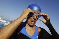 U.S. long-distance swimmer Diana Nyad adjusts her goggles before attempting to swim to Florida from Havana August 31, 2013. REUTERS/Enrique De La Osa