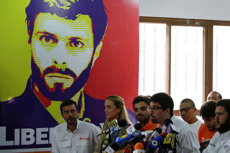 Lilian Tintori (C), wife of jailed Venezuelan opposition leader Leopoldo Lopez, attends a news conference in front of a poster depicting her husband at the office of the party Popular Will (Voluntad Popular) in Caracas, Venezuela March 13, 2017. REUTERS/Marco Bello