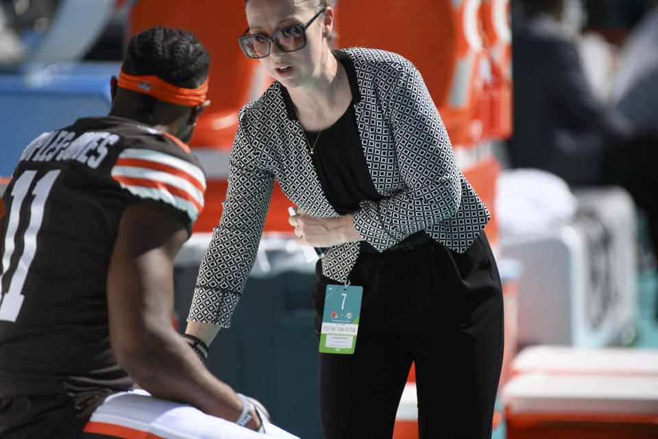 FILE - Cleveland Browns assistant general manager & vice president of Football Operations Catherine Raiche talks with Cleveland Browns wide receiver Donovan Peoples-Jones (11) on the sidelines before an NFL football game against the Miami Dolphins, Sunday, Nov. 13, 2022, in Miami Gardens, Fla. The Browns have hired more candidates from the NFL's Women's Forum than any team. (AP Photo/Doug Murray, File)