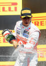 MONTREAL, CANADA - JUNE 10: Lewis Hamilton of Great Britain and McLaren celebrates on the podium after winning the Canadian Formula One Grand Prix at the Circuit Gilles Villeneuve on June 10, 2012 in Montreal, Canada. (Photo by Mark Thompson/Getty Images)