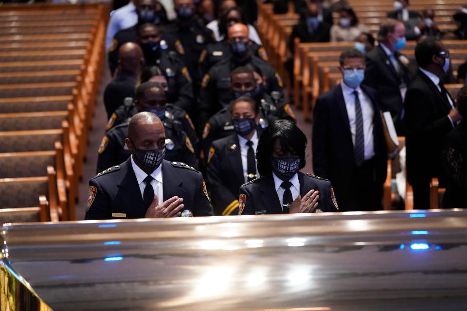 Members of the Texas Southern University Police Department pause during a funeral service for George Floyd at the Fountain of Praise Church in Houston on Tuesday. (David J. Phillip/AFP via Getty Images)