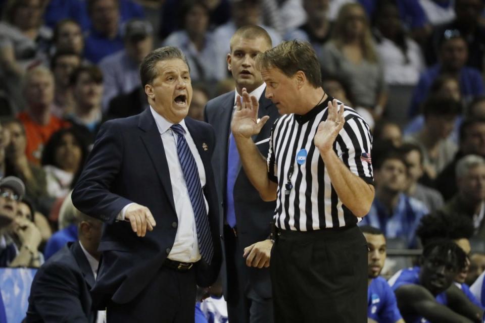 John Calipari argues with referee John Higgins over a call during Kentucky's 75-73 loss to North Carolina. (AP)