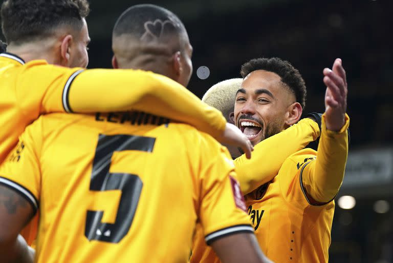 Matheus Cunha, del Wolverhampton Wanderers (derecha), celebra tras anotar el tercer gol de su equipo de penal en el tiempo añadido durante un partido de la tercera ronda de la Copa de la FA contra el Brentford, en el estadio Molineux, en Wolverhampton, Inglaterra, el 16 de enero de 2024. (Jacob King/PA vía AP)