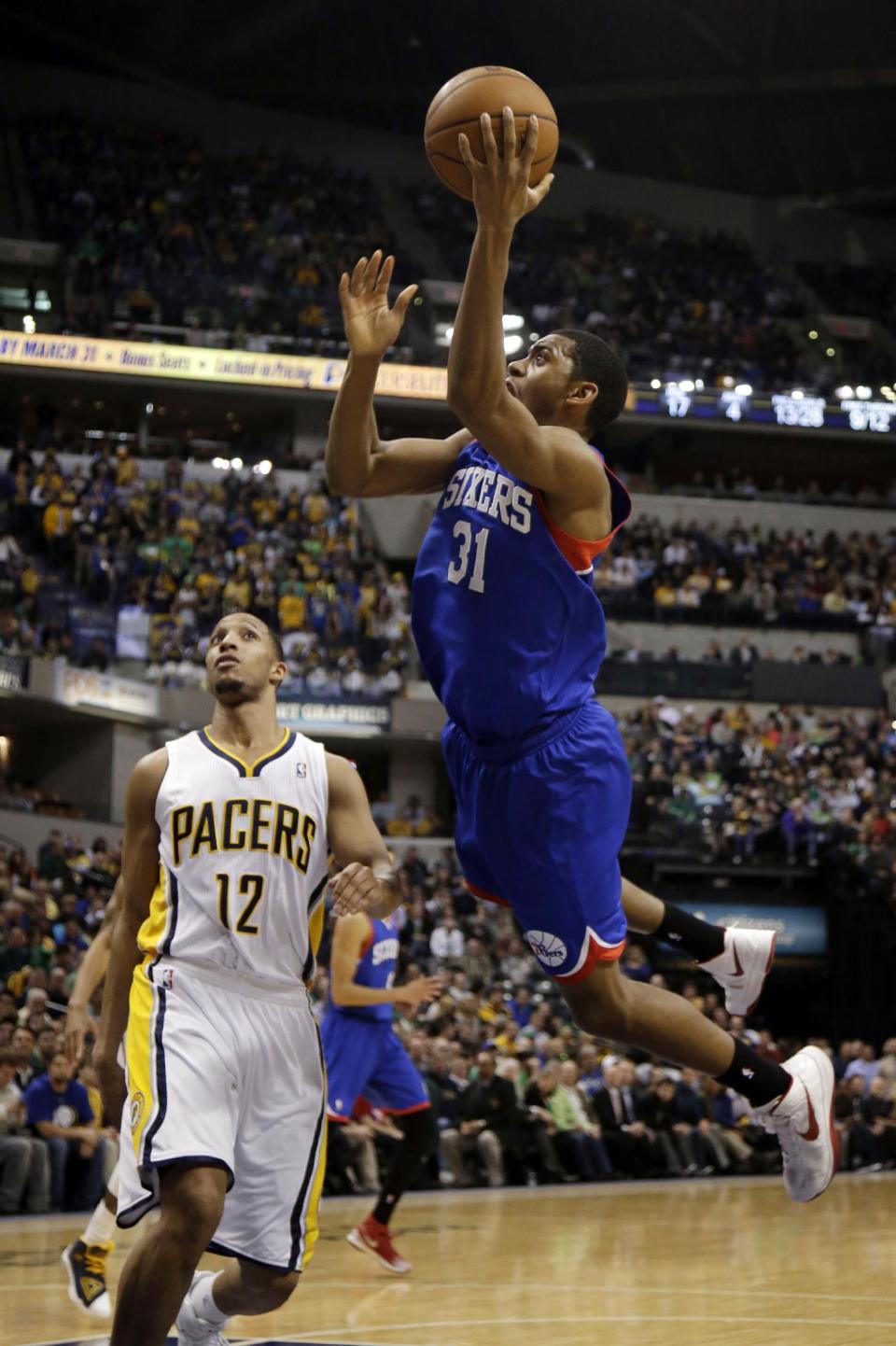 Philadelphia 76ers guard Hollis Thompson (31) shoots in front of Indiana Pacers forward Evan Turner (12) during the first half of an NBA basketball game in Indianapolis, Monday, March 17, 2014. (AP Photo/AJ Mast)