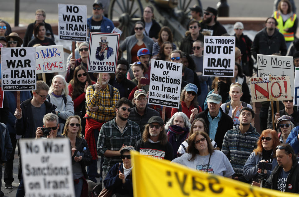 Participants hold up placards during a protest against recent United States military actions in Iraq Saturday, Jan. 4, 2020, outside the state Capitol in downtown Denver. Close to 500 protesters were on hand for the rally and march to voice opposition to the killing of a top Iranian general and Iraqi militiamen in an airstrike that has heightened tensions across the Middle East. (AP Photo/David Zalubowski)