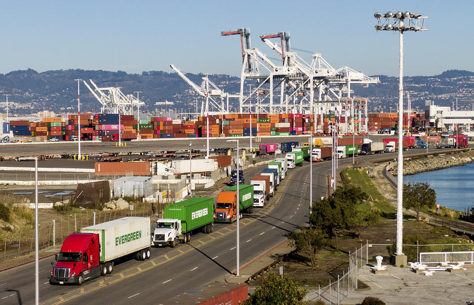 FILE - Trucks line up to enter a Port of Oakland shipping terminal on Nov. 10, 2021, in Oakland, Calif. Intense demand for products has led to a backlog of container ships outside the nation's two largest ports along the Southern California coast. (AP Photo/Noah Berger, File)