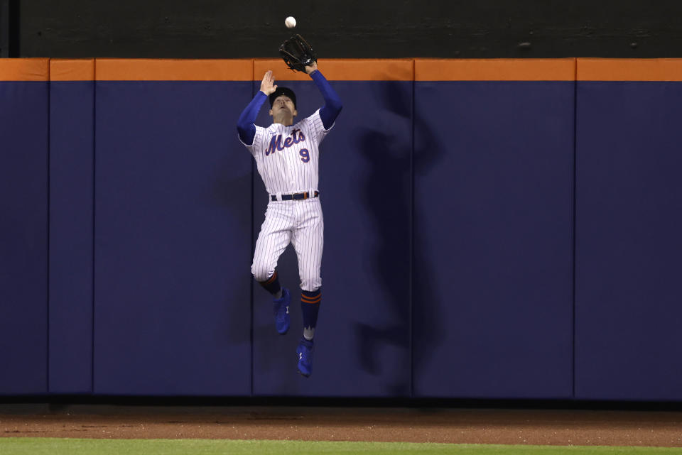 New York Mets center fielder Brandon Nimmo makes a catch on a flyout by Philadelphia Phillies designated hitter Bryce Harper during the fourth inning of a baseball game on Saturday, April 30, 2022, in New York. (AP Photo/Adam Hunger)