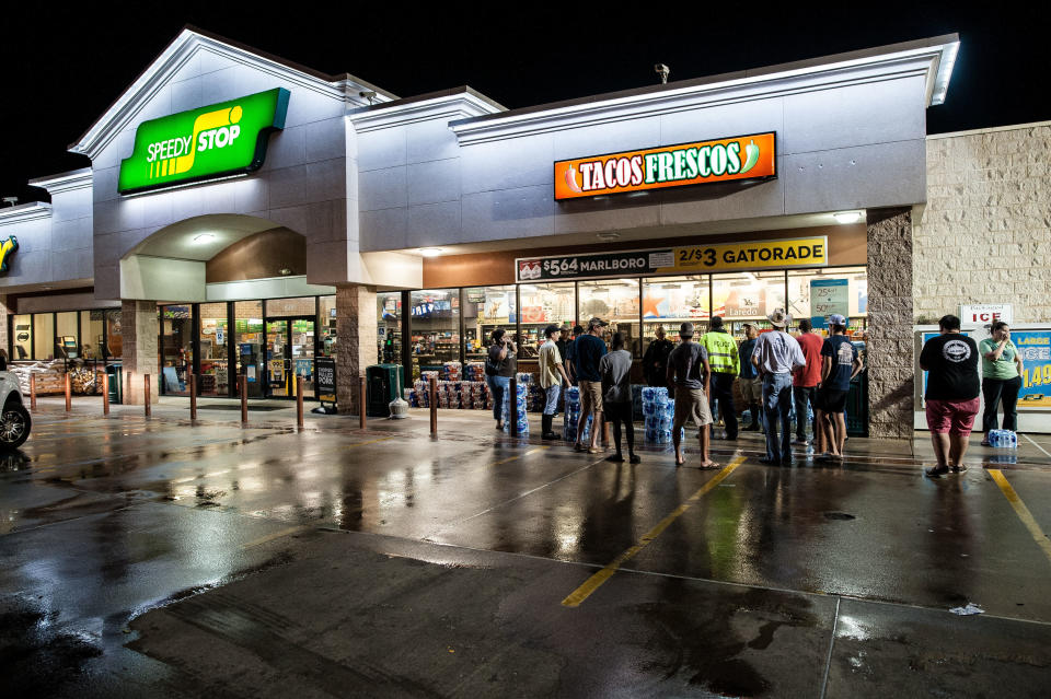 Beaumont residents&nbsp;wait outside a local convenience store after the city loses its water supply. (Photo: Joseph Rushmore for HuffPost)