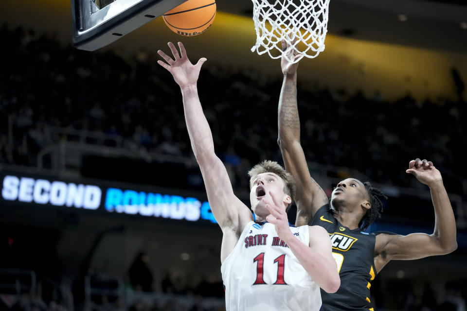 St. Mary's Mitchell Saxen (11) shoots against Virginia Commonwealth's Jamir Watkins (0) in the second half of a first-round college basketball game in the NCAA Tournament, Friday, March 17, 2023, in Albany, N.Y. (AP Photo/John Minchillo)