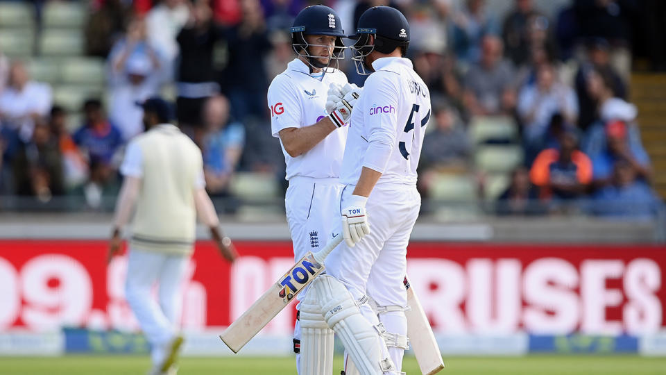 Joe Root and Johnny Bairstow speak together on the pitch during the first Test between England and India.