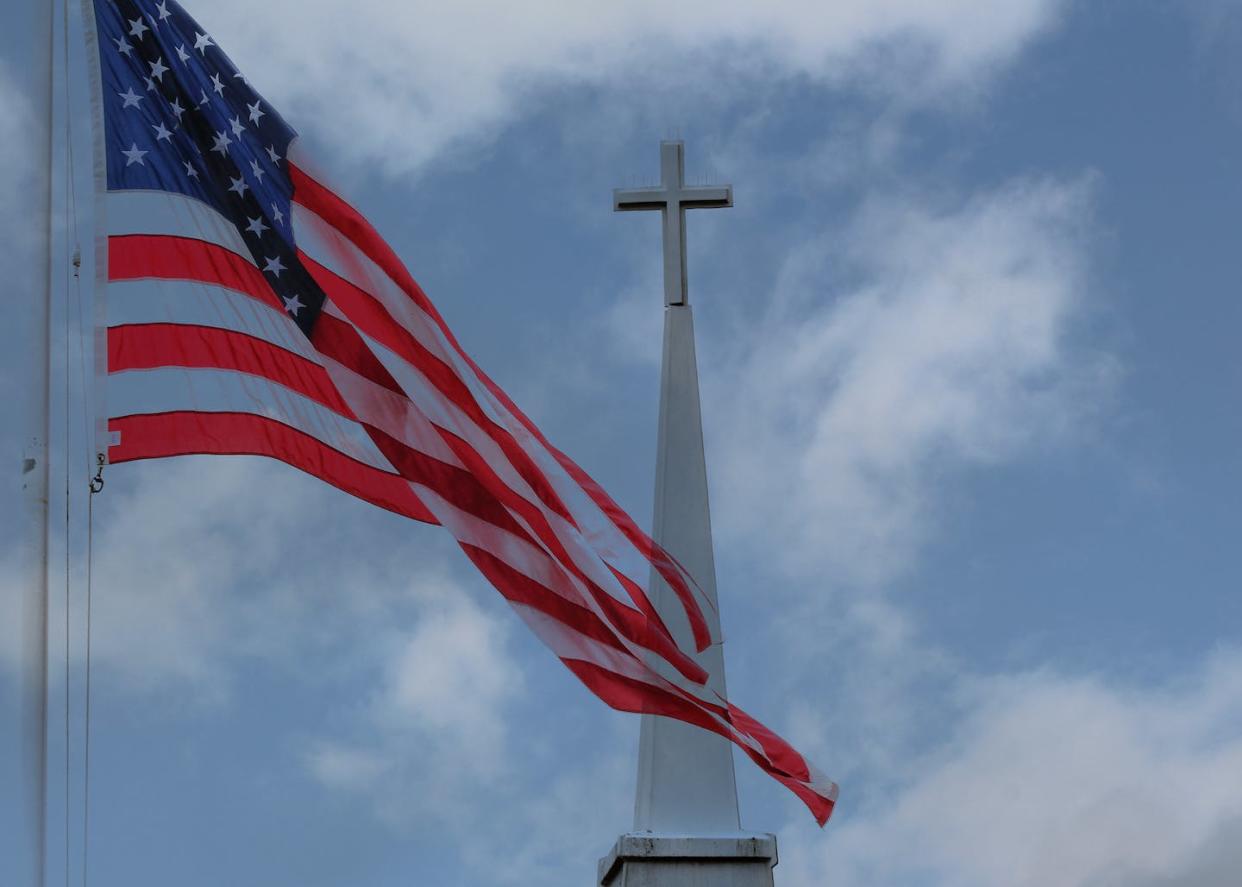 Separation of church and state: no longer so separate? <a href="https://www.gettyimages.com/detail/photo/the-flag-and-the-cross-royalty-free-image/1058861544?adppopup=true" rel="nofollow noopener" target="_blank" data-ylk="slk:Amanda Wayne/iStock/Getty Images Plus;elm:context_link;itc:0;sec:content-canvas" class="link ">Amanda Wayne/iStock/Getty Images Plus</a>