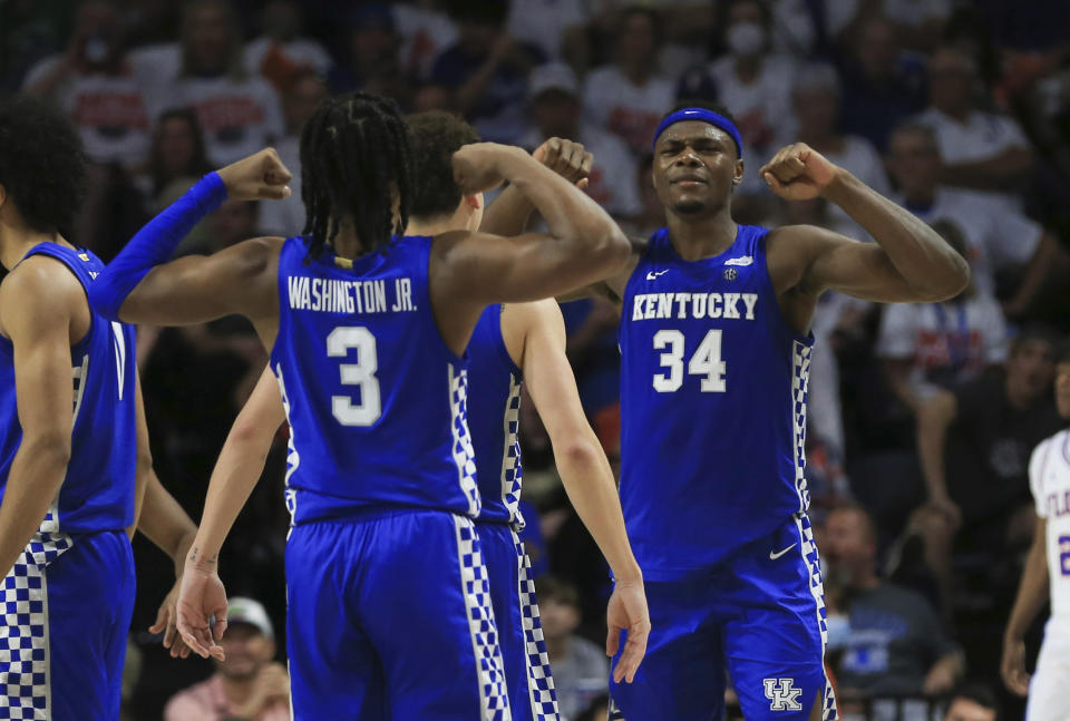 Kentucky forward Oscar Tshiebwe (34) and guard TyTy Washington Jr. (3) celebrate after a play against Florida during the second half of an NCAA college basketball game Saturday, March 5, 2022, in Gainesville, Fla. (AP Photo/Matt Stamey)