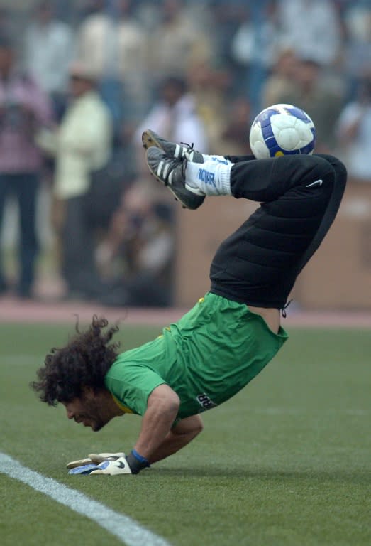 Former Colombian goalkeeper Rene Higuita controls the ball during a Golbang exhibition match between the Brazilian Masters and Indian All Stars in Kolkata on December 8, 2012