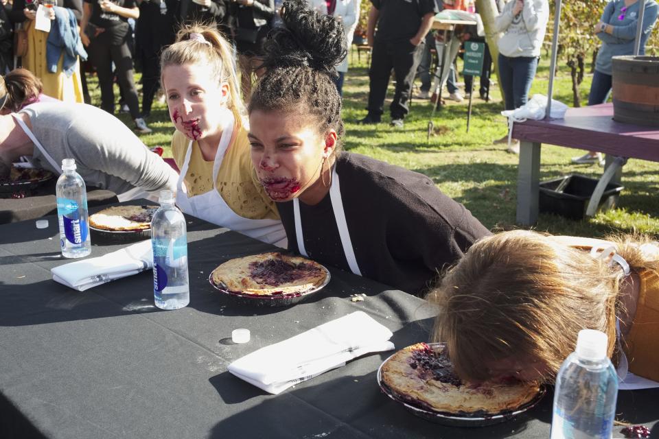 Contestants during the pie-eating contest at the Harvest Festival in 2019.