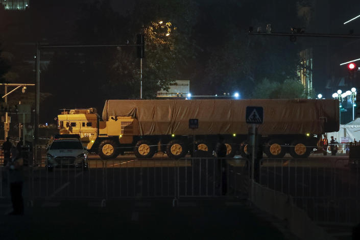 In this Saturday, Sept. 21, 2019, photo, a Chinese military vehicle carrying a covered-up ballistic missile passes along the Jianguomenwai Avenue during a rehearsal for the 70th anniversary of Communist China, in Beijing. A parade on Tuesday, Oct. 1 by China’s secretive military will offer a rare look at its rapidly developing arsenal, including possibly a nuclear-armed missile that could reach the United States in 30 minutes, as Beijing gets closer to matching Washington and other powers in weapons technology. (AP Photo/Andy Wong)