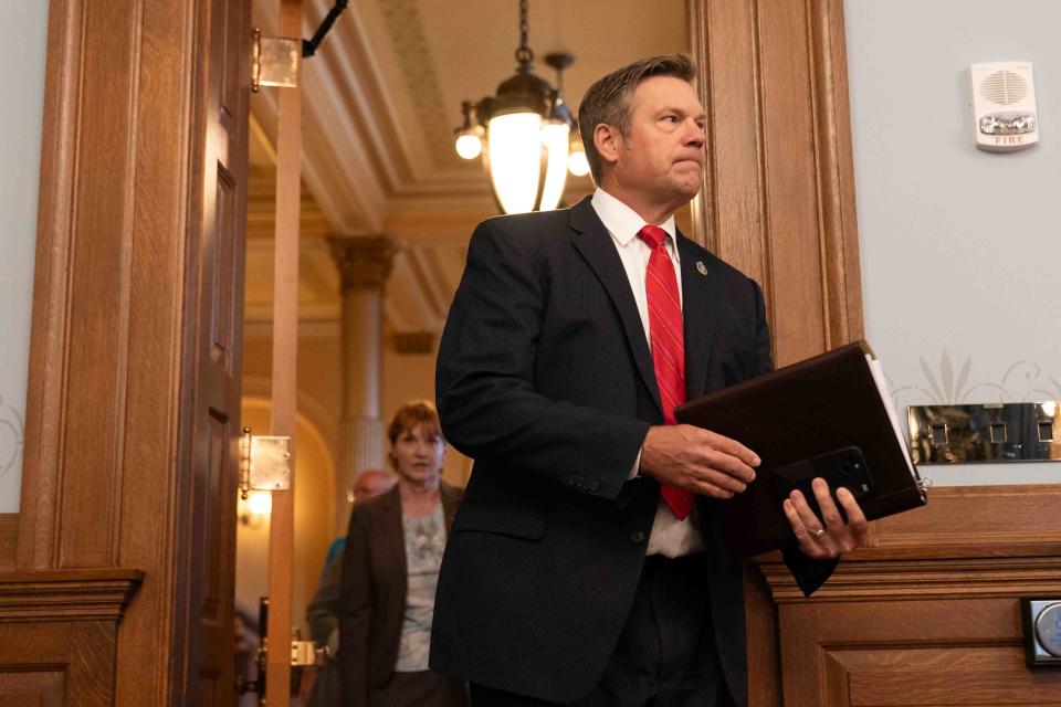 Kansas Attorney General Kris Kobach enters a room at the Statehouse for a press conference where he laid out a lawsuit he plans to file over the Pfizer COVID-19 vaccine Monday.