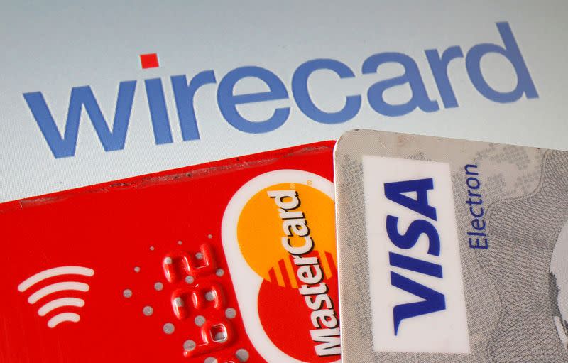 Mastercard and Visa credit cards are seen in front of displayed Wirecard logo in this illustration picture