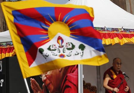 Tibetan spiritual leader the Dalai Lama addresses devotees outside the United Nations where the Human Rights Council is holding it's 31st Session in Geneva, Switzerland, March 11, 2016. REUTERS/Denis Balibouse