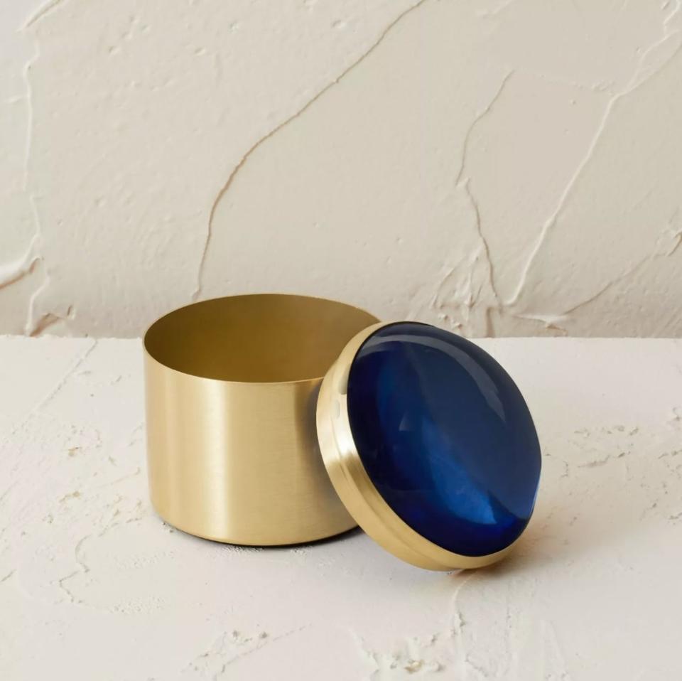gold round box with blue resin top